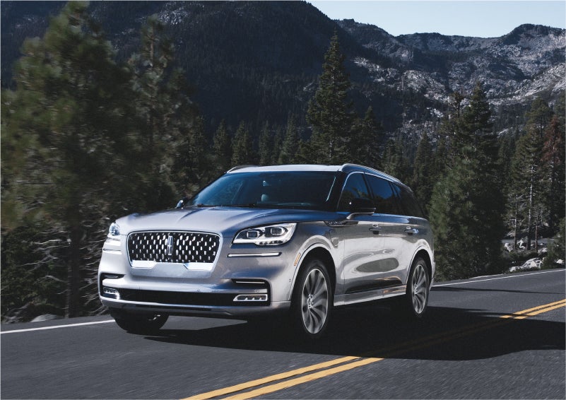 A 2023 Lincoln Aviator® Grand Touring SUV being driven on a winding road to demonstrate the capabilities of all-wheel drive | Thomasville Lincoln in Thomasville GA