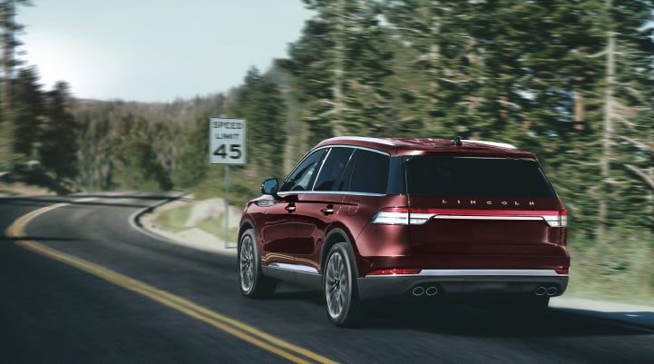 A 2024 Lincoln Aviator® SUV is being driven on a winding mountain road | Thomasville Lincoln in Thomasville GA